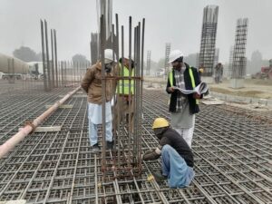 קבלנים ומנהל עבודה באתר בנייה בשלב השלד